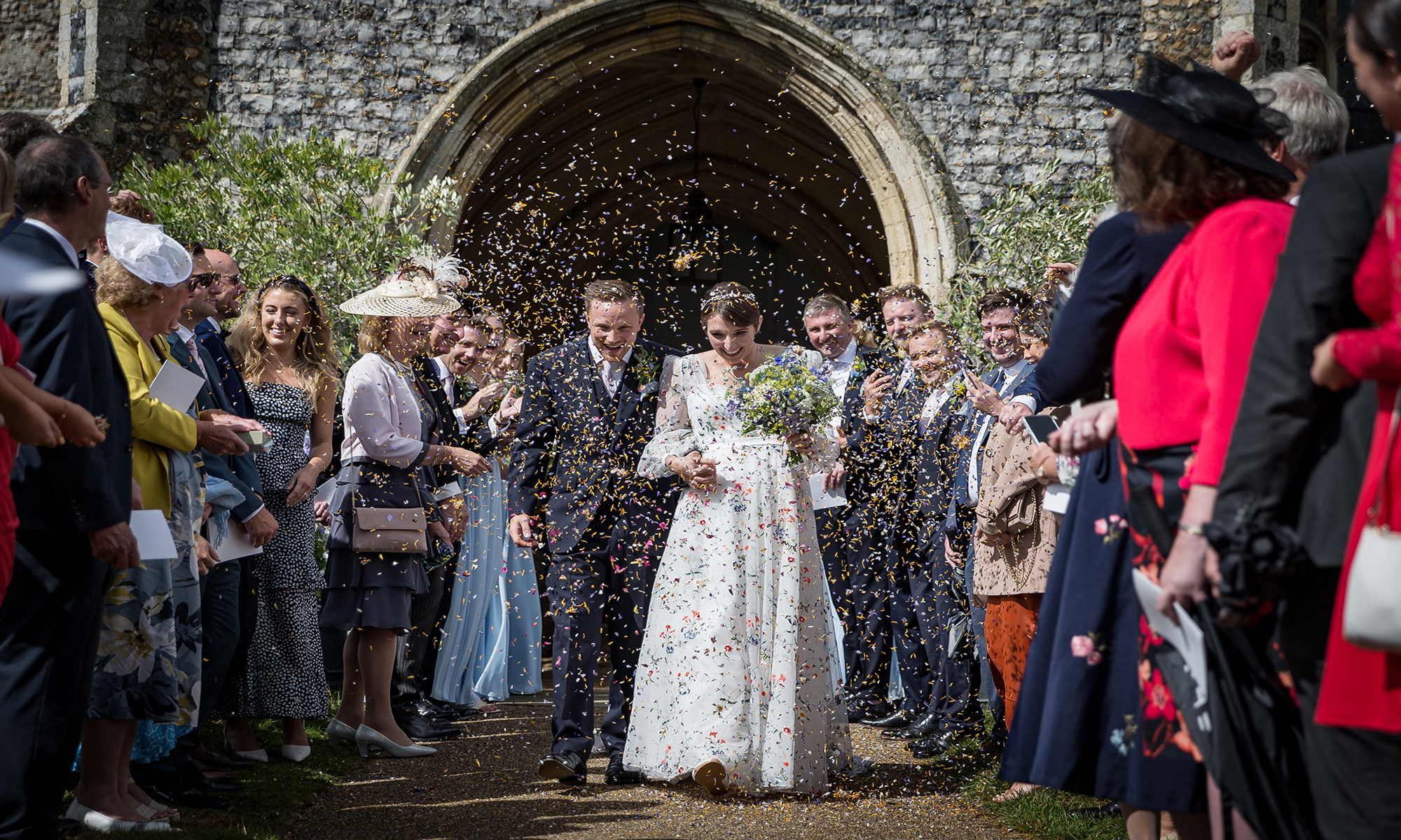 Bride and Groom leaving Church with confetti being thrown