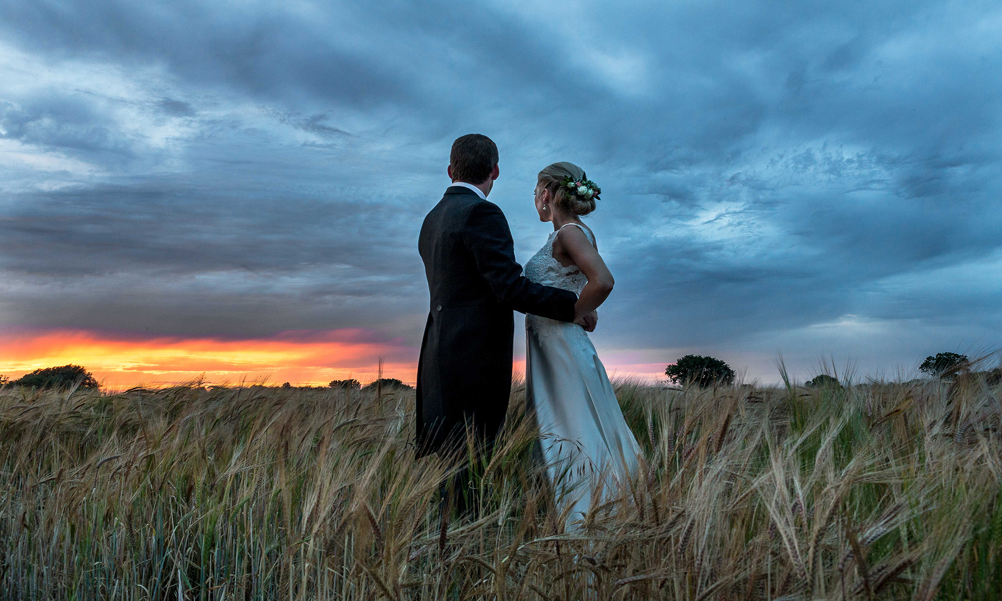 Newly Wed Couple posing infront of a beautiful sunset